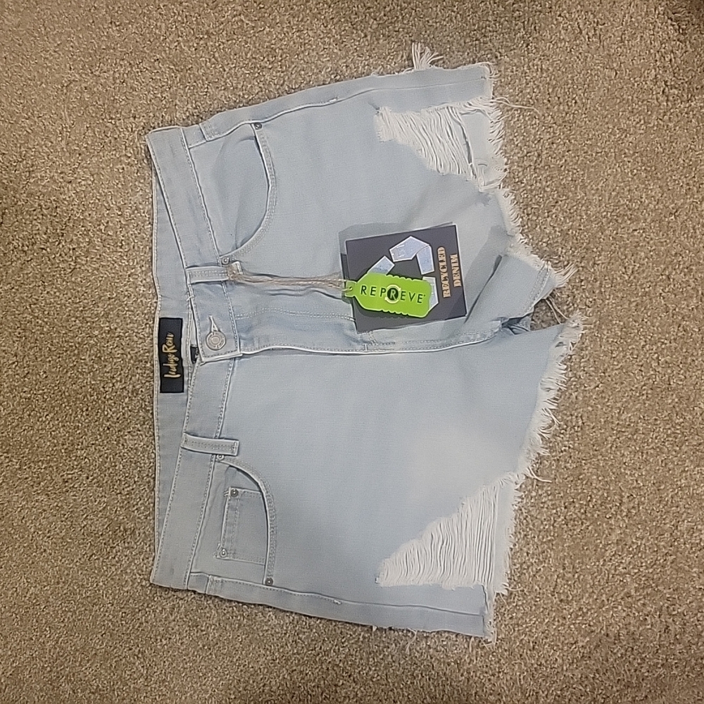 Indigo Rein high rise distressed light wash denim shorts.  Size 15/31